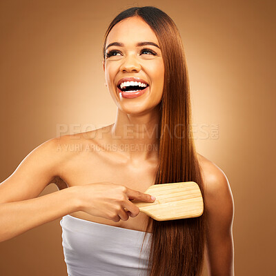 Buy stock photo Hair brush, beauty and a happy woman in studio for growth and color shine or texture. Aesthetic female thinking, brushing and laugh for natural haircare, and hairdresser or salon on brown background
