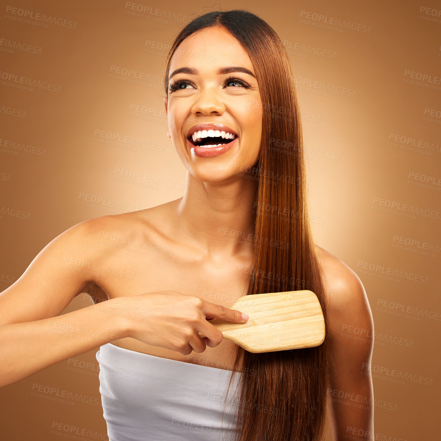 Buy stock photo Hair brush, beauty and a happy woman in studio for growth and color shine or texture. Aesthetic female thinking, brushing and laugh for natural haircare, and hairdresser or salon on brown background
