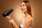 Hairdryer, beauty tools and happy woman with hair care, face and blow drying on brown background. Cosmetics, equipment and keratin treatment with mockup, female with smile in studio and shine