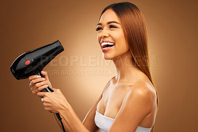 Buy stock photo Hairdryer, beauty tools and happy woman with hair care, face and blow drying on brown background. Cosmetics, equipment and keratin treatment with mockup, female with smile in studio and shine