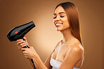 Hairdryer, beauty tools and woman with smile, hair care and face with blow drying on brown background. Cosmetics, equipment and keratin treatment with mockup, happy female in studio with eyes closed