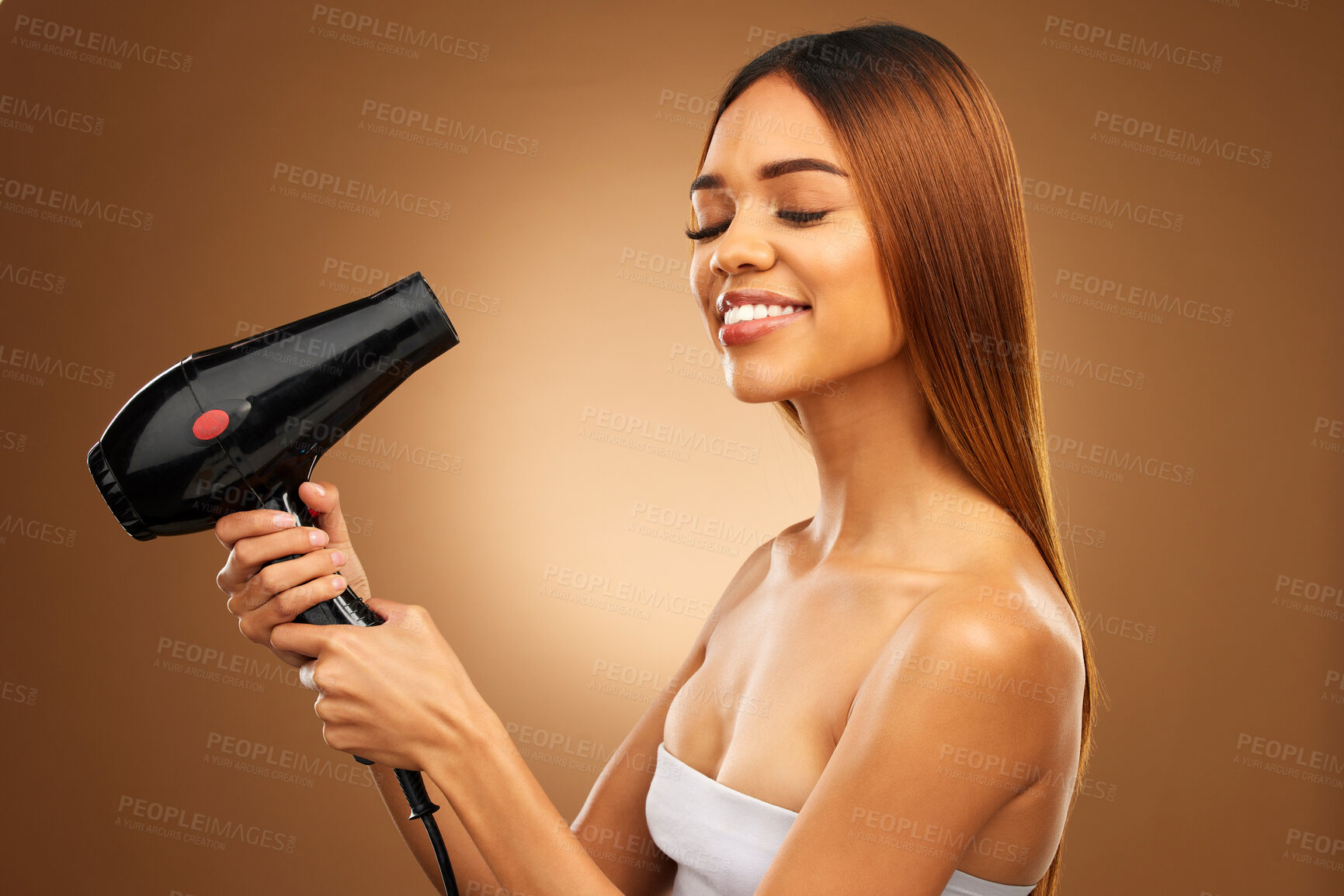 Buy stock photo Hairdryer, beauty tools and woman with smile, hair care and face with blow drying on brown background. Cosmetics, equipment and keratin treatment with mockup, happy female in studio with eyes closed