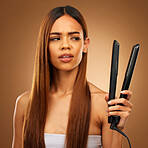 Hair, flat iron and confused woman in studio for beauty, wellness and keratin treatment on brown background. Hairdresser mockup, salon and girl with hairstyle for heat, haircare texture and cosmetics