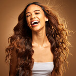 Freedom, hair and excitement with a model woman on a brown background in studio for natural haircare. Happy, salon and shampoo with an attractive young female feeling excited by keratin treatment