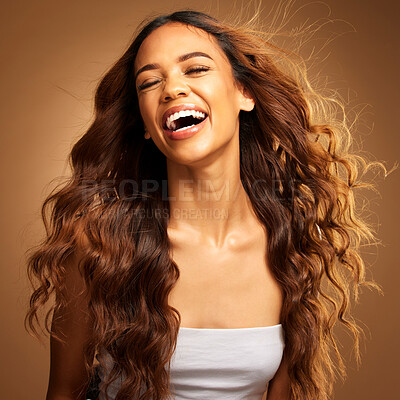 Buy stock photo Freedom, hair and excitement with a model woman on a brown background in studio for natural haircare. Happy, salon and shampoo with an attractive young female feeling excited by keratin treatment