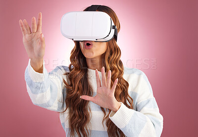 Buy stock photo Virtual reality, metaverse and innovation with a woman using a headset to access the virtual world of gaming. AI, 3D and VR with a female gamer in studio on a pink background using future technology