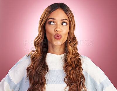 Buy stock photo Kiss, face and studio with a woman with kissing, love and emoji expression feeling silly. Playful, fun and pink background of a young female model with a funny, comedy and joke with casual fashion