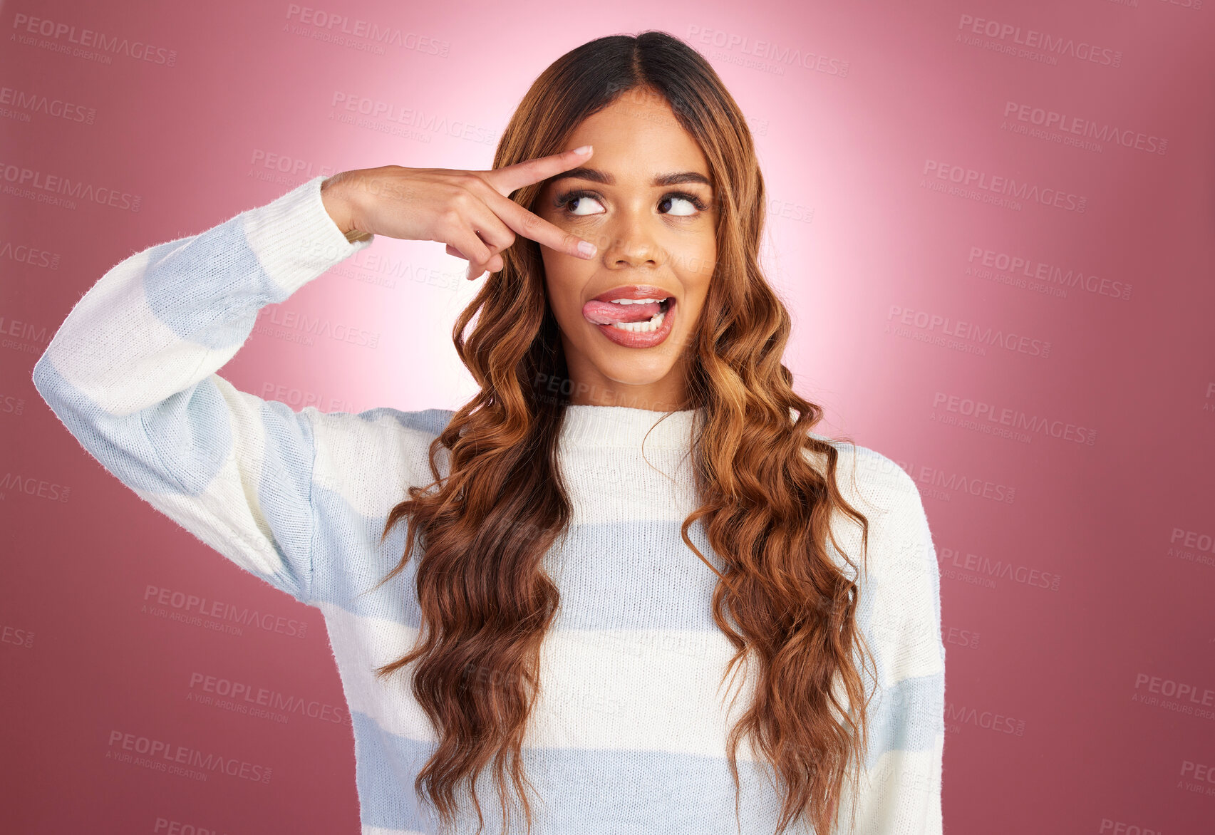 Buy stock photo Comic face, peace sign and tongue of a woman in studio on a gradient pink background feeling silly. Young female fashion model looking playful and having fun with hand on eyes for cute or goofy emoji