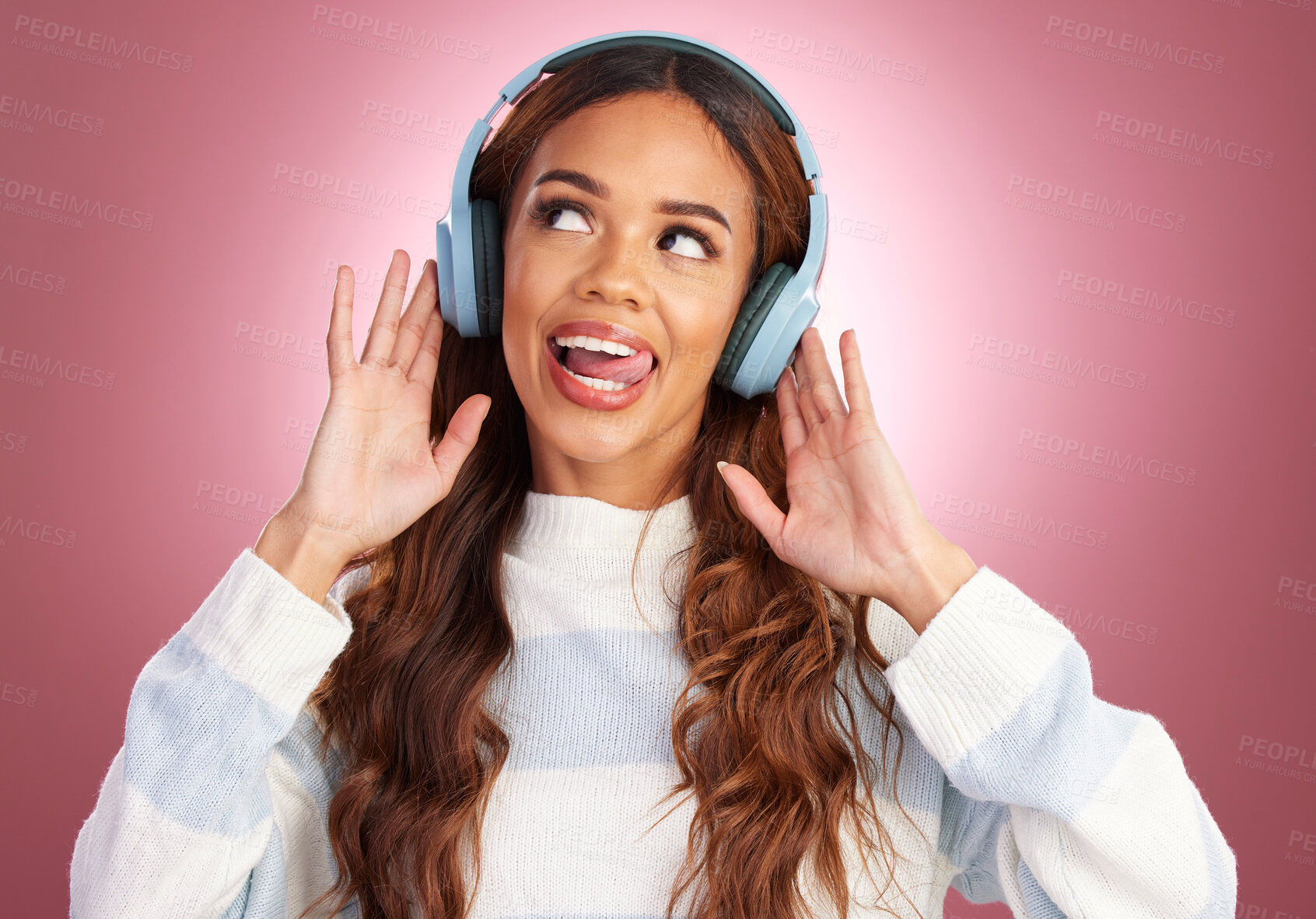 Buy stock photo Mockup, tongue out and woman with headphones, streaming music and happy against a pink studio background. Headset, female and lady with joy, silly and listening to radio with audio, song and sounds