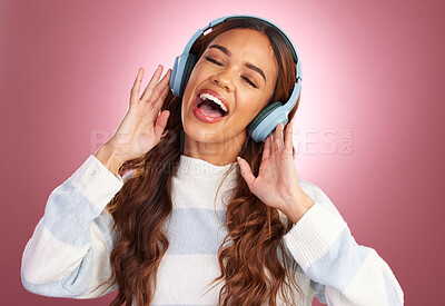 Buy stock photo Mockup, sing and woman with headphones, streaming music and happiness against pink studio background. Female, happy lady and headset for sounds, listening to radio or audio for wellness or motivation