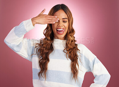 Buy stock photo Hand, woman and tongue out in studio, crazy and having fun against red background. Face, emoji and gen z girl model posing, young and confident, playful and goofy, casual and comic while isolated