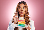 Surprise, cake and taste with woman in studio for birthday, party and event. Rainbow, dessert and celebration with young female isolated on pink background for food, happiness and festive treat