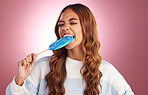 Lollipop, bite and woman in studio with sugar snack, happy and having fun against a pink background. Sweet candy, satisfaction and girl eating dessert, silly and posing while isolated on mockup