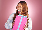 Gift, portrait and happy woman in studio with present for birthday, celebration or prize on pink background. Smile, box and face of girl with package, giveaway or party gesture while posing isolated