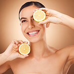 Skincare, lemon and woman face cleaning of a young person with happiness in a studio. Happy, smile and dermatology of a female with cosmetics, spa aesthetic and healthy fruit for wellness facial