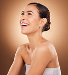 Studio face, laugh and beauty woman with luxury facial cosmetics, natural makeup and skincare glow. Dermatology healthcare satisfaction, spa salon person or aesthetic female model on brown background