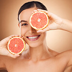 Beauty, health portrait and happy woman with grapefruit for fruit detox, healthcare or natural facial skincare routine. Vitamin c food product, studio face and female nutritionist on brown background