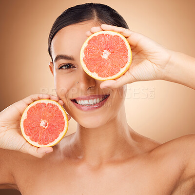 Buy stock photo Beauty, health portrait and happy woman with grapefruit for fruit detox, healthcare or natural facial skincare routine. Vitamin c food product, studio face and female nutritionist on brown background