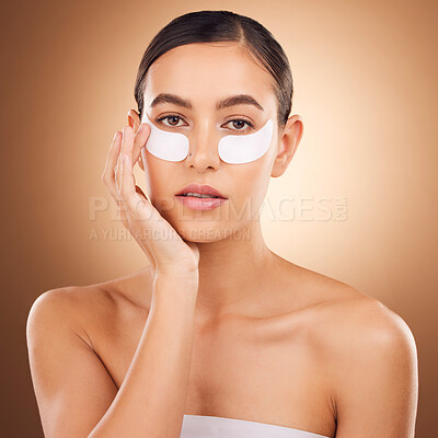 Buy stock photo Skincare, portrait or woman with eye patch for studio dermatology, face healthcare or beauty treatment. Spa care, facial collagen product or female model with hyaluronic acid mask on brown background