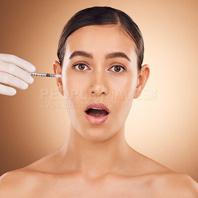 Buy stock photo Plastic surgery surprise, hands or woman face with needle facial change, spa cosmetics process or studio skincare. Wow, medical injection or portrait female with aesthetic beauty on brown background