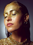 Gold, woman luxury and beauty sparkle of a female with makeup and cosmetic glitter. Creative fashion, cosmetics and  face glow of a young person with eyeshadow shimmer and golden sparkles in studio