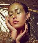 Gold, woman model and beauty sparkle of a female with makeup and cosmetic glitter. Creative fashion, cosmetics and yellow face glow of a young person with eyeshadow art shimmer and golden sparkles