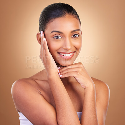 Buy stock photo Beauty, skincare and touch with portrait of indian woman in studio for happy, spa and facial. Cosmetics, self care and glow with model on brown background for satisfaction, makeup and confidence