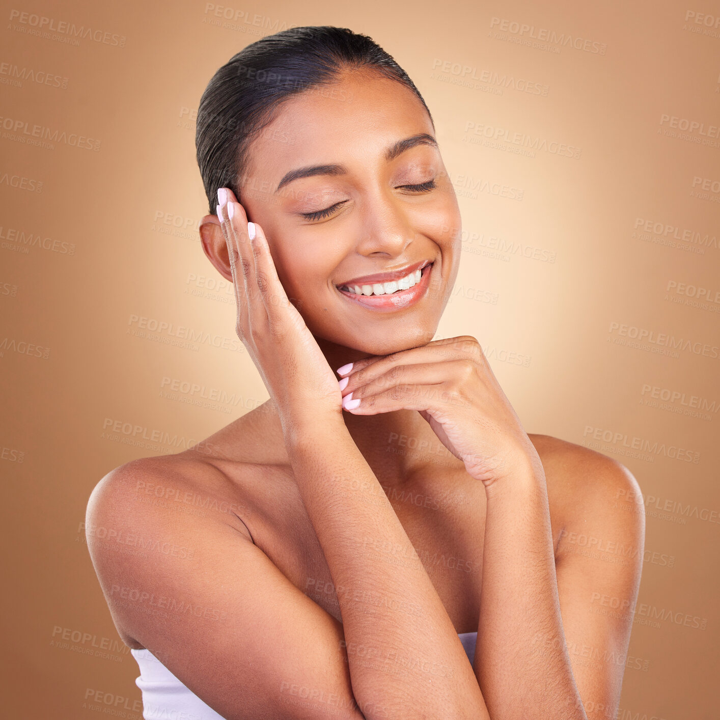 Buy stock photo Beauty, skincare and happy with indian woman and touch in studio for happy, spa and facial. Cosmetics, self care and glow with model on brown background for satisfaction, makeup and confidence