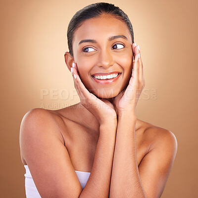 Buy stock photo Beauty, skincare and touch with indian woman in studio for happy, spa treatment and facial. Cosmetics, self care and glow with model on brown background for satisfaction, empowerment and confidence