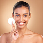 Beauty, skincare and cotton with portrait of indian woman in studio for self care, makeup remover and cosmetics. Happy, clean and glow with model on brown background for results, natural and facial