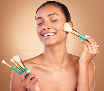 Buy stock photo Makeup brushes, smile and woman with natural beauty, wellness and happiness from cosmetics. Facial skin glow, happy and cosmetic artist brush of a young female model with self care in a studio