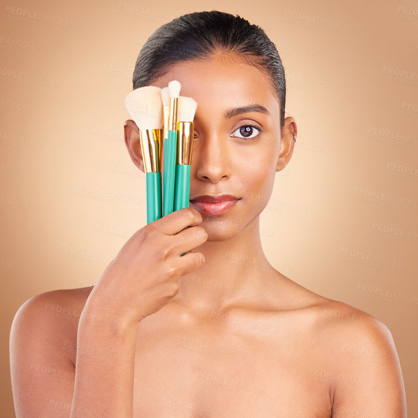 Buy stock photo Makeup, cover and brush with portrait of Indian woman in studio for foundation, blush and self care. Glow, cosmetics and facial with female model on brown background for shine, clean and confidence