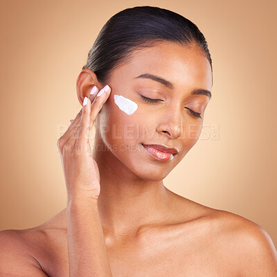 Buy stock photo Beauty, skincare and face of Indian woman with cream in studio for wellness, glowing and spa products. Salon, dermatology and girl with lotion cosmetics, moisturizer makeup and anti aging products