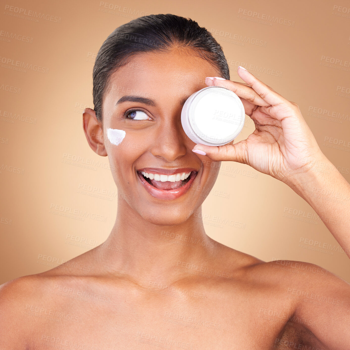 Buy stock photo Indian woman, skincare cream and jar in studio with smile, happiness and wellness by brown background. Happy model, lotion product and face with thinking, dermatology and young with cosmetic beauty