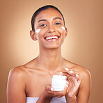 Indian woman, skincare cream and jar in hands for portrait, health and wellness by brown background. Young model, lotion product and studio with aesthetic, dermatology and clean with cosmetic beauty