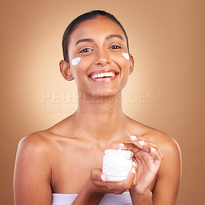 Buy stock photo Indian woman, skincare cream and jar in hands for portrait, health and wellness by brown background. Young model, lotion product and studio with aesthetic, dermatology and clean with cosmetic beauty