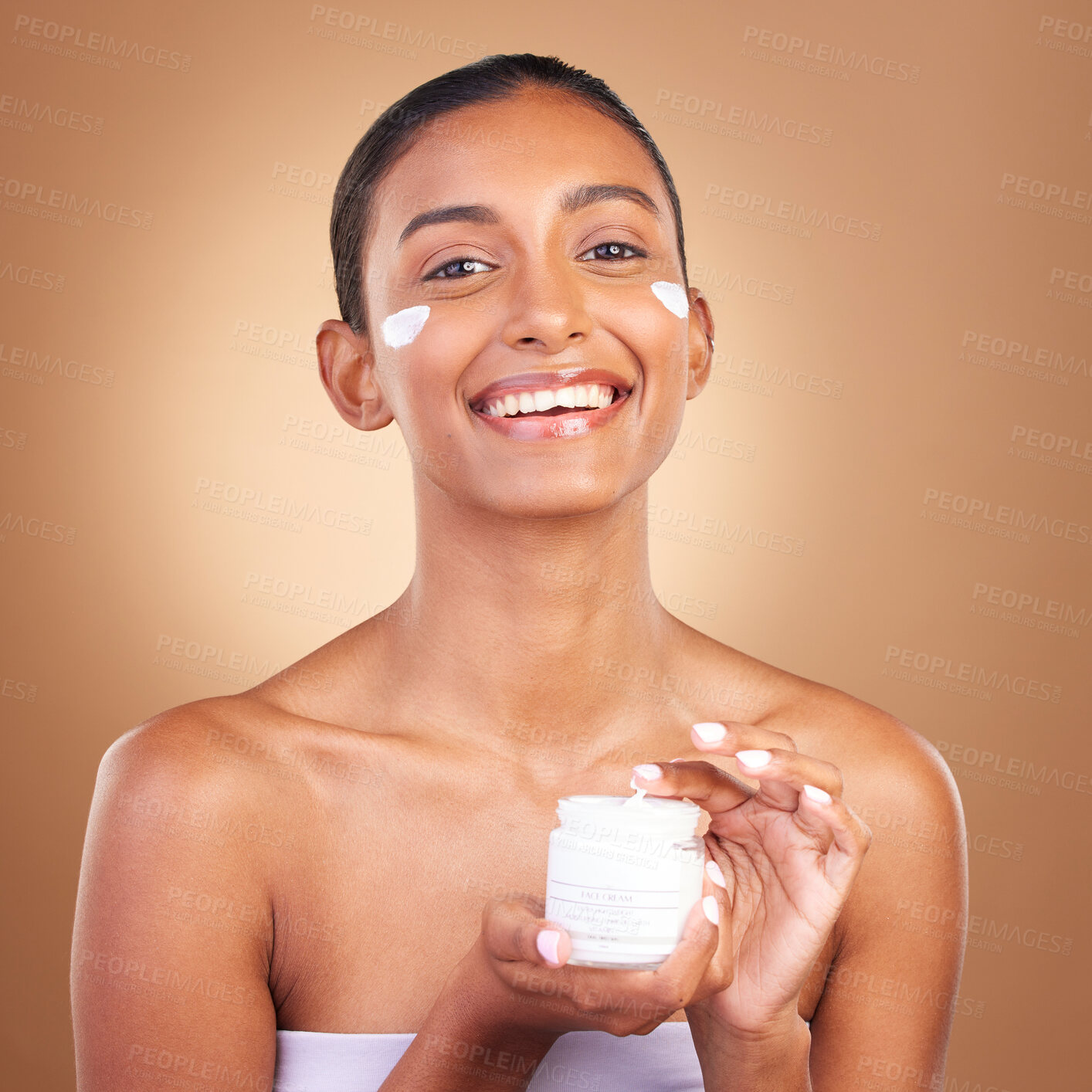 Buy stock photo Indian woman, skincare cream and jar in hands for portrait, health and wellness by brown background. Young model, lotion product and studio with aesthetic, dermatology and clean with cosmetic beauty