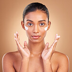 Indian woman, skincare cream and hands in portrait with health, serious or wellness by brown background. Young model, lotion product or face with aesthetic, dermatology and clean with cosmetic beauty