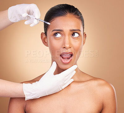 Buy stock photo Woman, syringe and shock face in studio for cosmetic, surgery or wow for pain in forehead by background. Young, model and needle for facial skin, cosmetics and collagen filler for dermatology change