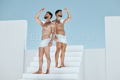 Buy stock photo Cover, creative and men on building stairs and looking for shade in an open space. Macho, together and couple or friends on steps covering from sun on a construction site for creativity and posing