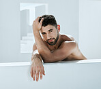 Gay, skincare and portrait of non binary man doing self care in a modern bathroom for hygiene and cosmetic beauty. Model, lgbtq and person relax and calm in a white room for skin treatment