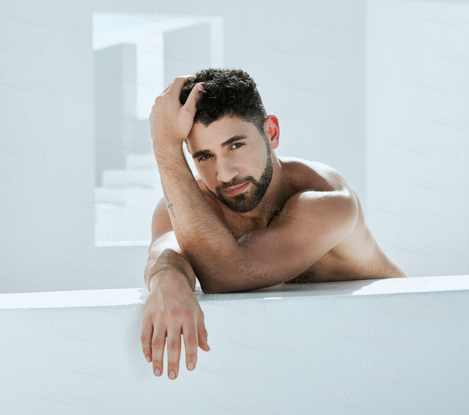 Buy stock photo Handsome, building and shirtless man outside in a modern bathroom for creativity and commercial model. Guy, body and artistic person relax, young and calm in a white room relaxing or chilling