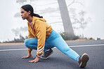 Outdoor fitness leg stretching, woman and runner exercise on a road in the mountains with focus. Workout, running training and wellness of a young female ready for sports and marathon run in mist