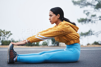 Buy stock photo Sports, leg stretching and woman runner doing exercise on a outdoor road feeling serious. Workout, running training and wellness warm up of young female ready for sports and marathon run in mist