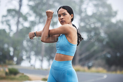 Buy stock photo Arm stretching, woman focus and runner exercise on a outdoor road in the mountains in morning. Workout, running training and wellness of a young female ready for sports and marathon run in mist