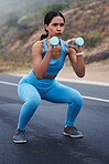 Fitness, outdoor and woman doing a exercise with weights for strength, wellness and health. Sports, cardio and young female athlete doing a workout or training with equipment in nature in the road.