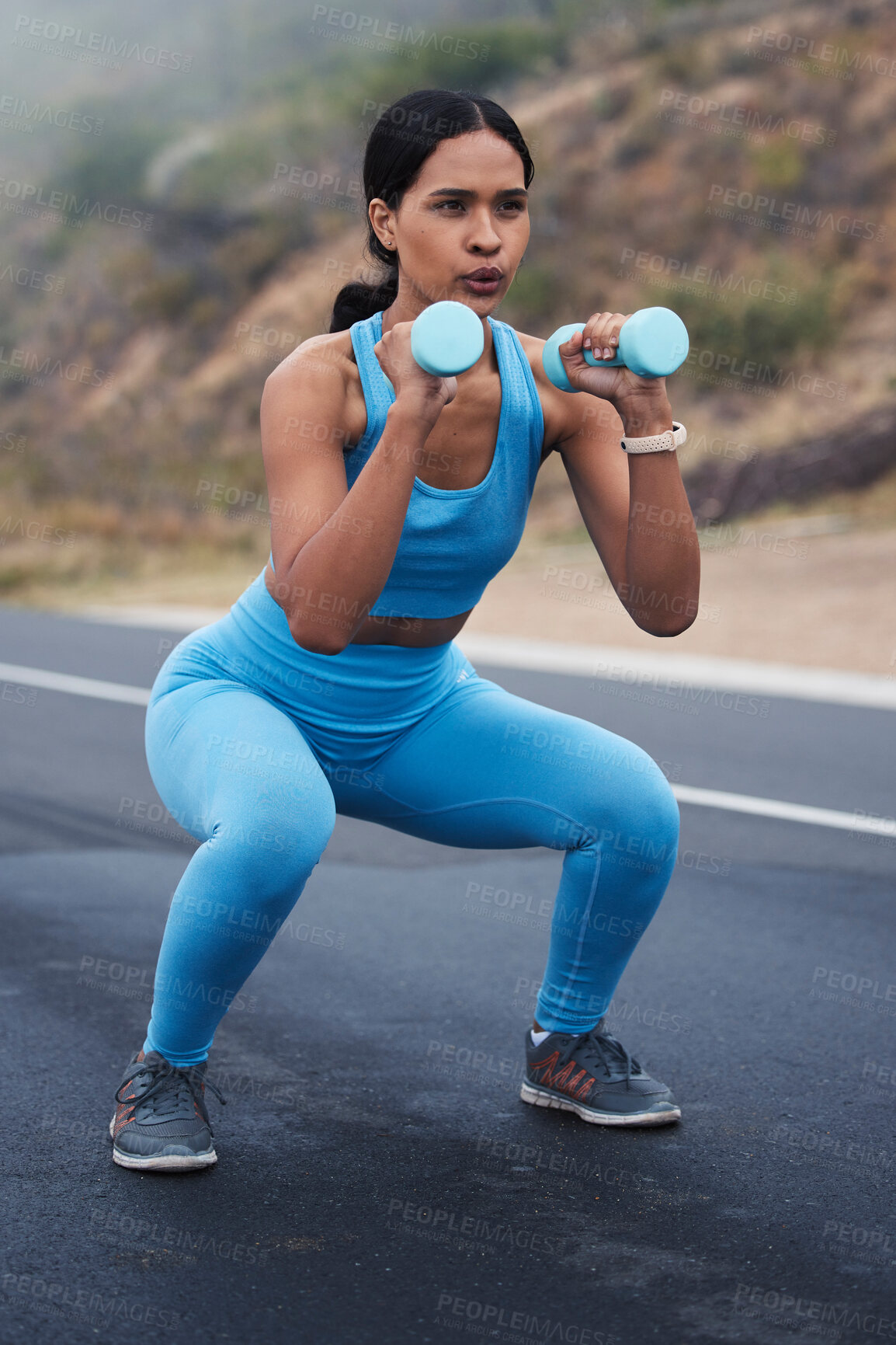 Buy stock photo Fitness, outdoor and woman doing a exercise with weights for strength, wellness and health. Sports, cardio and young female athlete doing a workout or training with equipment in nature in the road.