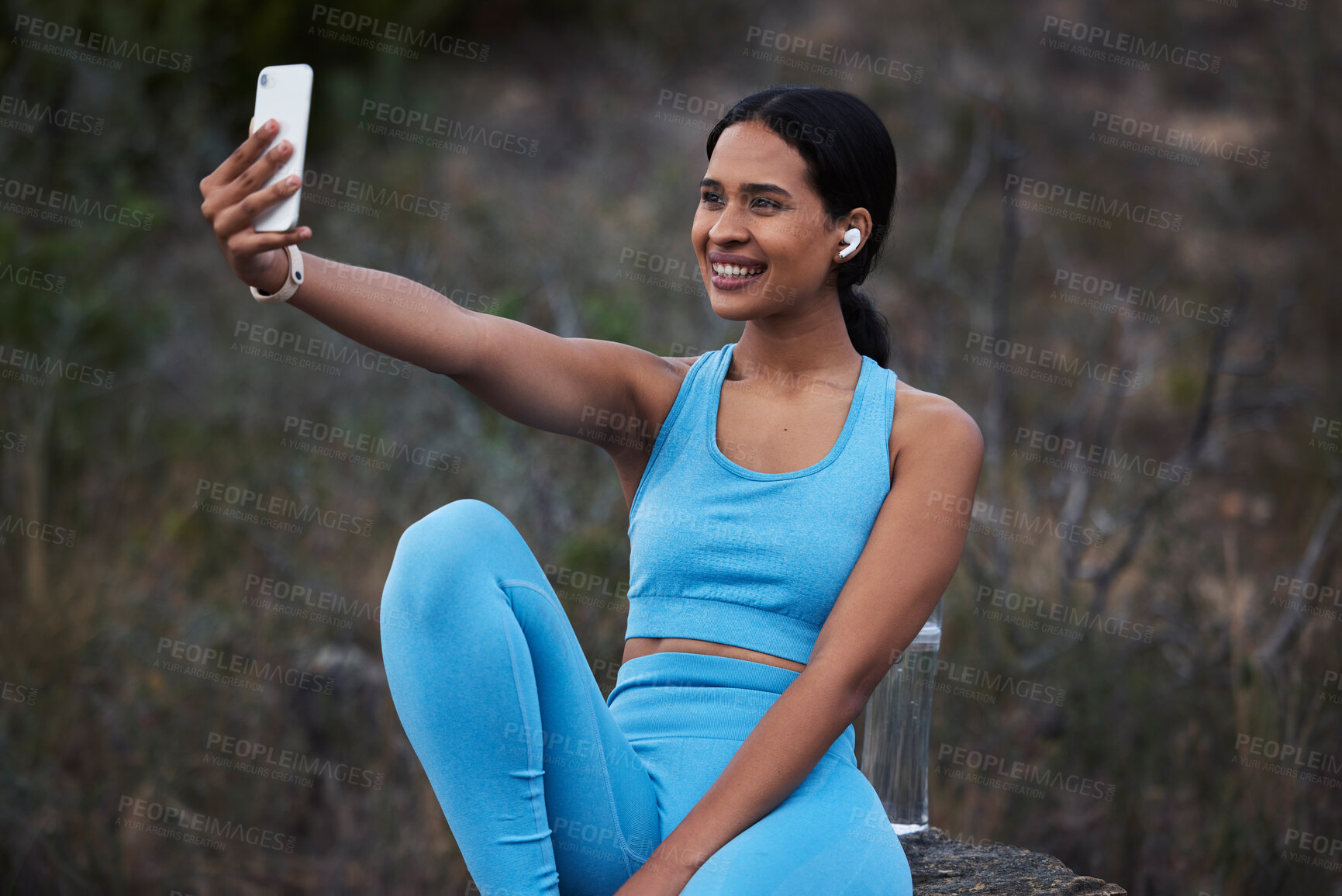Buy stock photo Woman outdoor, runner and fitness selfie, smile with earphones and running in nature with live streaming for social media. Exercise, cardio and happy in picture, break after run and listen to music