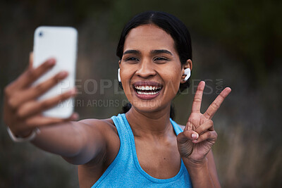 Buy stock photo Selfie, peace and fitness with a sports woman outdoor, taking a picture during her cardio or endurance workout. Exercise, running and smile with a happy young female athlete posing for a photograph