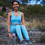 Woman, portrait or fitness break in nature training, exercise or workout for cardiology, wellness or athlete sports. Smile, happy or relax runner sitting in remote park for outdoor marathon running